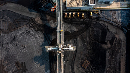 Aerial top view moving belt with heap of coal next to the coal power plant, Coal mining view from above, © Darunrat