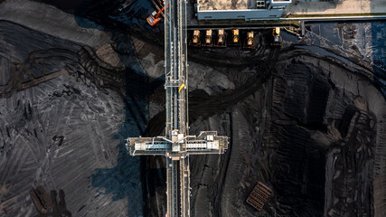 Aerial top view moving belt with heap of coal next to the coal power plant, Coal mining view from above, © Darunrat