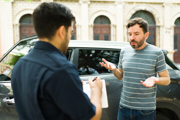 Angry young man arguing with a cop about his parking fine