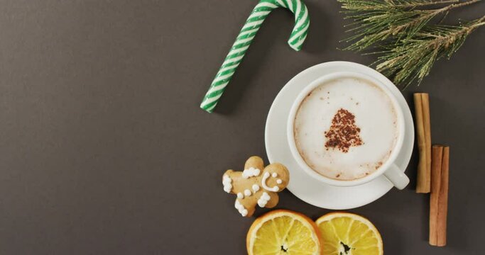 Video of cup of hot chocolate with cinnamon over grey background