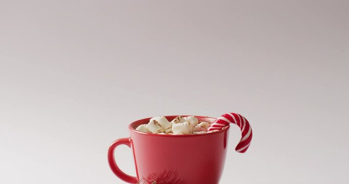 Video of cup of hot chocolate with marshmallows over white background