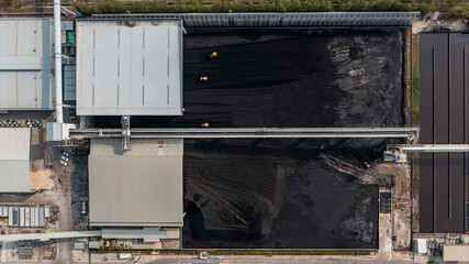 Aerial top view moving belt with heap of coal next to the coal power plant, Coal mining view from above, © Darunrat