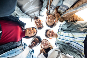 Multiracial friends together in a circle looking at camera