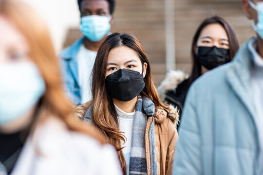 Multiracial people in the city wearing face mask