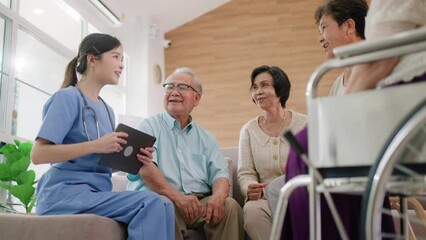 Group of asian senior people listening to young nurse.Psychological support group for elderly therapy session in a community centre. Group therapy in session sitting in a circle in a nursing home.