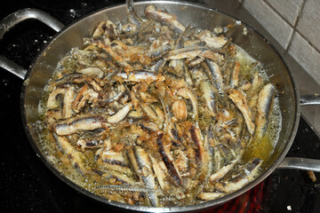 frying pan with many anchovies