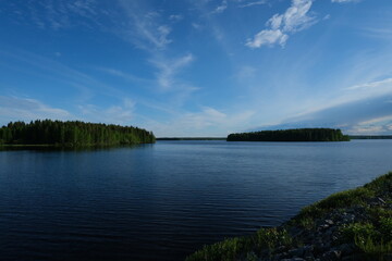 Fototapeta na wymiar Beautiful blue lake, summertime, wild lake in the forest