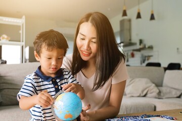 mother and child playing with globe
