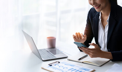 Beautiful Indian businesswoman using her mobile phone in the office