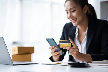 Asian businesswoman hands holding smartphone shopping online with a credit card. Online Payment. Online shopping