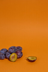 Blue Plums on orange background
