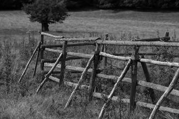 an old wooden fence on a field in black and white
