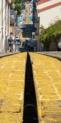 Tram track and tram car parked at the base from the point of view of the track from the bottom to the top of the hill. Viseu. - obrazy, fototapety, plakaty