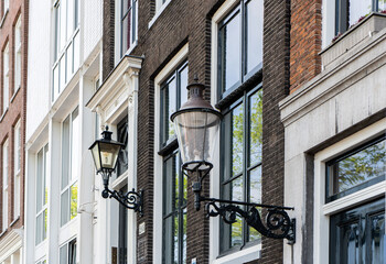 Details and facades of Amsterdam characteristic brick construction of residential building in...
