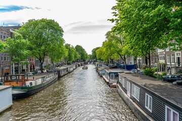 Fototapeta premium Amstedam, Holland Netherlands on the Dutch canals of amstedam on a cold day and with so much haze