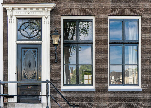 Typical house entrance with door, windows in the old town of Amsterdam, Netherlands