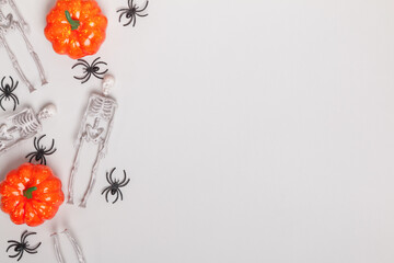Halloween composition of skeletons of pumpkin spiders. Top view copy space flat lay