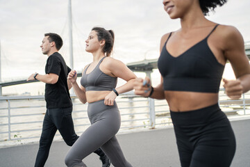 Group of friends training fast running in sportswear.
