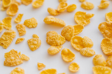 top view of crispy and dry corn flakes on white background.