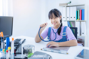 Young Asian girl wear stethoscope play act doctor.
