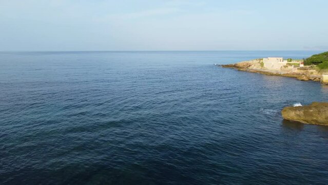 Drone view in a sunnylight day over the Alghero coast in Sardinia, Italy