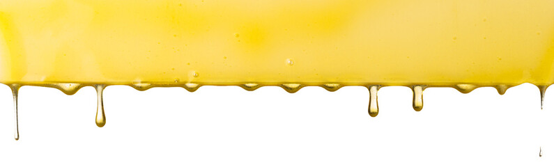 Liquid dripping oil on a white background. Golden drops of honey.