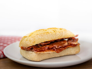 Closeup of crispy bacon in a sourdough roll