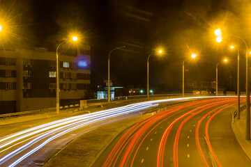 View from the bridge to the night highway with traces of car headlights..