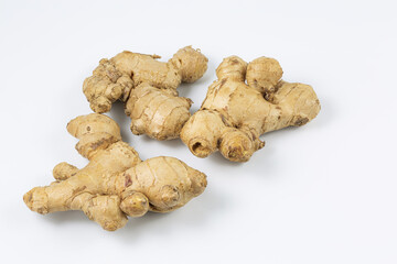 ginger on a white background,yellow fresh ginger laying on a white background