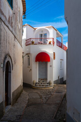 Narrow street in Anacapri on Capri island Campania Italy. Small village with picturesque walkways and small ancient houses. Popular tourist destination and summer vacation spot in mediterranean sea.