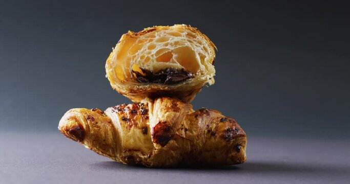 Video of close up of croissants on gray background