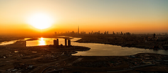 Aerial sunset view Dubai city skyscrapers Persian Gulf