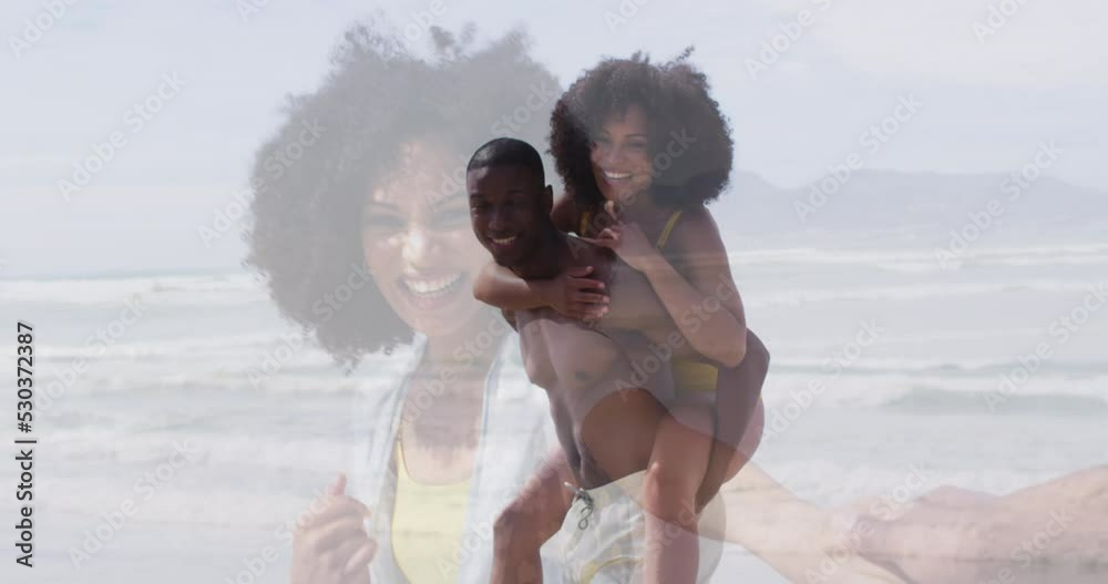 Sticker Animation of happy african american couple piggybacking on beach over woman beckoning partner to sea