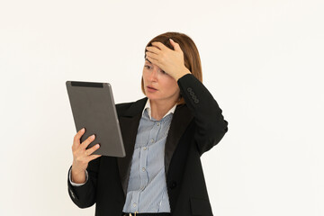 Young attractive business woman in black suit holding gadget and putting hand on her head isolated on white. Copy space and place for text concept