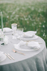 A reserved wedding table with crockery and decor.