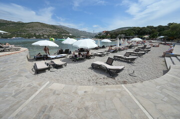 Fototapeta na wymiar People sunbathing on holiday on a beach in Croatia.