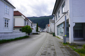 Eine Straße in Nordfjordeid mit schönen weißen Holzhäusern in Norwegen