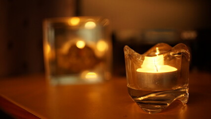 Candle light in glass small jar. dark night background,easter day concept