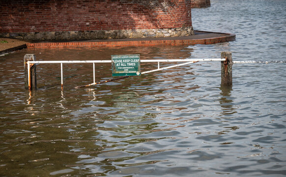 Flood barrier, partially submerged by the high tide, across the entrance to Langstone harbour, Hayling Island.
