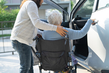 Asian senior or elderly old lady woman patient sitting on wheelchair prepare get to her car, healthy strong medical concept.