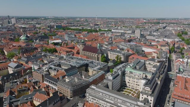 Cityscape on sunny day. Aerial view of Trinitatis Church and Round Tower and surrounding town development. Copenhagen, Denmark