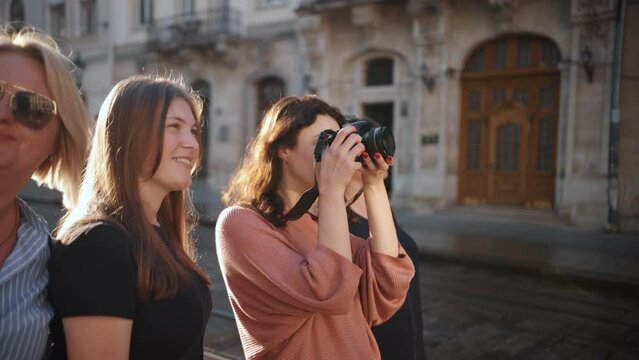 The group of female tourists relax on the old streets of the city and enjoy the rest, travel, and take pictures of the sights. Go Everywhere