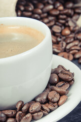 Coffee in cup and roasted dark coffee beans in bag