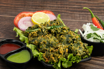 Indian Spinach Pakoda Also Called Palak Pakora, Pikora, Bhajiya, Pakodi, Ponako, Pakura, Fakkura, Phulauri, Bora, Bajji Made Of Green Leaves mixed With Gram Flour Besan, Spices, Masala, Organic Herbs