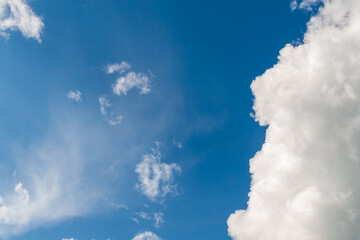 Natural background of white clouds on blue sky. Summer sky. White clouds on blue sky with copy space.
