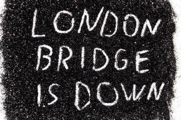 Fototapeta premium It is code name of the operation when the Queen of the England die written on the black glitter - LONDON BRIDGE IS DOWN.