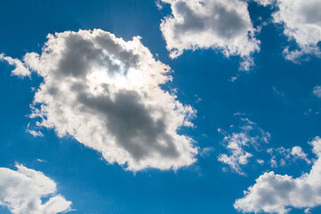 Clouds illuminated by the sun from behind. ummer sky. The sun is behind the cloud.