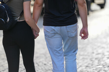heterosexual couple. couple walking on the street, detail.