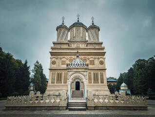 Fototapeta na wymiar Curtea de Arges old Christian Orthodox monastery in Romania. Beautiful Cathedral facade and architectural details from the legend of Manole craftsman