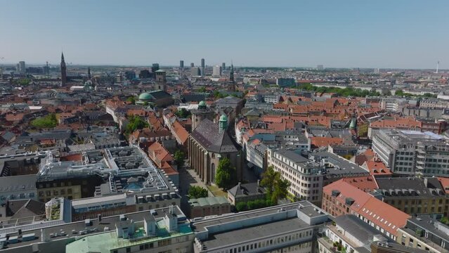 Aerial panoramic view of Trinitatis Church and Round Tower. Cinematic footage of town development on sunny day. Copenhagen, Denmark